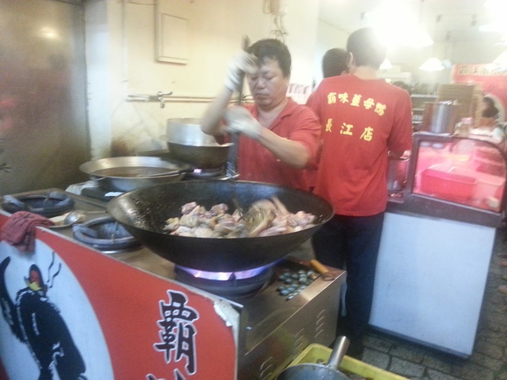 Frying the duck in ginger and sesame oil
